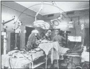 The file shows a hospital operating theater during a surgical procedure with medical staff gathered around the patient table.